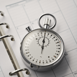 Stopwatch resting on a planner page, symbolizing focused time management and 90-day action planning in church leadership.